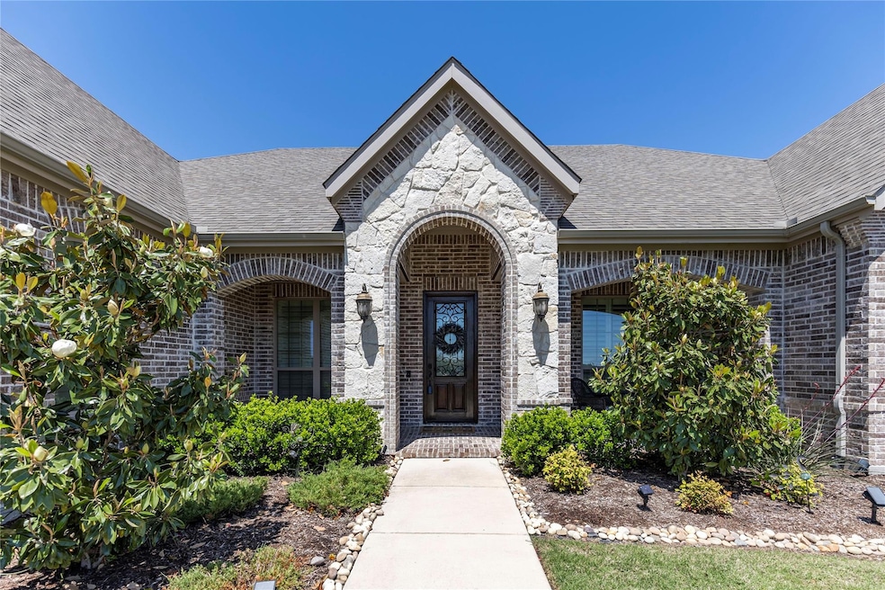 Solid wood, stained front door with glass and iron accents is just the beginning of the elegance of this home.
