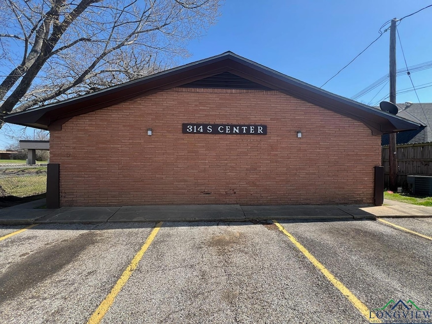 View of property exterior featuring brick siding, 