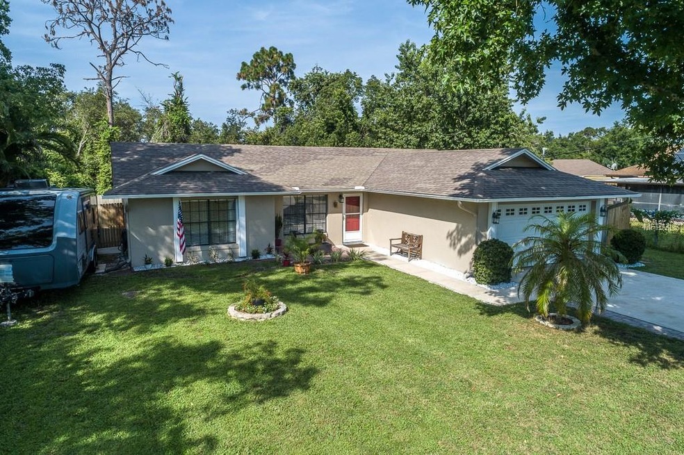 Beautifully landscaped 3/2/2 home with RV/boat par