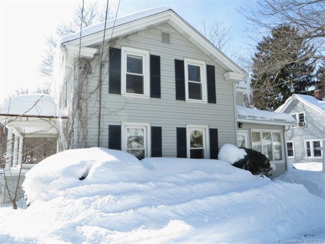 FRONT OF HOME WITH SMALL SIDE PORCH AND ENCLOSED F