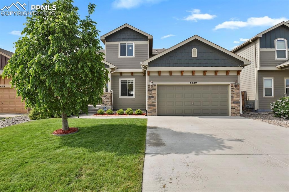 Beautifully landscaped yard with beautiful flowers, lush green grass and trees and an automatic sprinkler system for easy maintenance and year-round curb appeal.