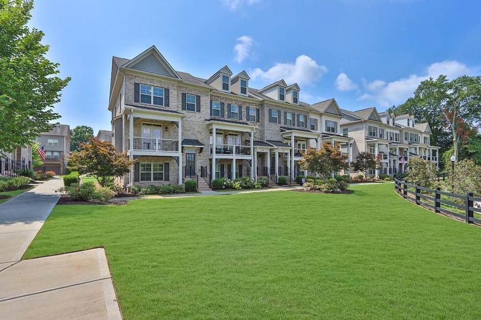 View of property featuring a front lawn