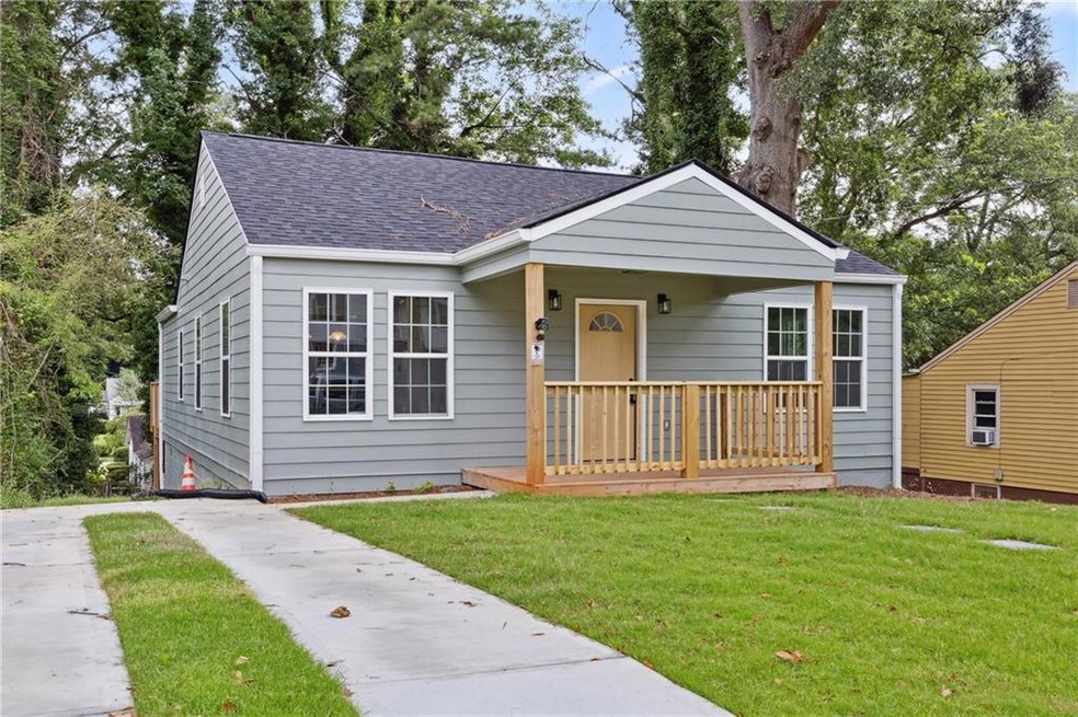 Bungalow-style home with a front yard, a shingled roof, and a porch