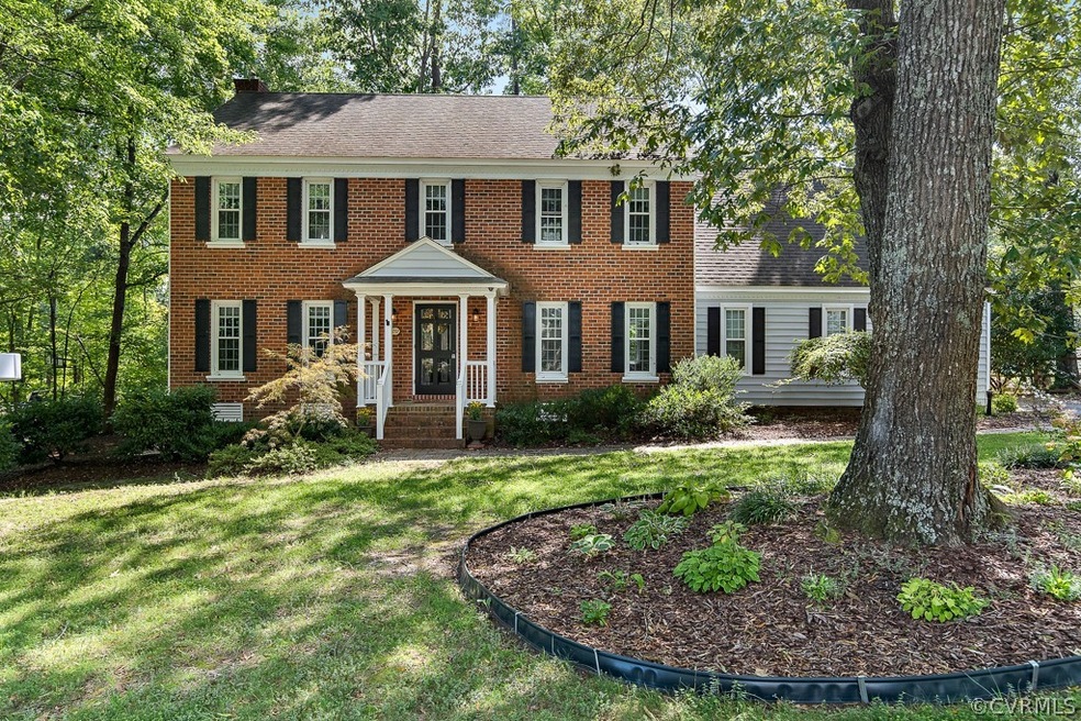 Welcoming home with brick and vinyl siding.