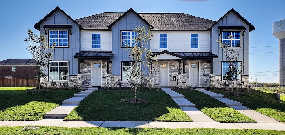 View of front facade with a standing seam roof, a metal roof, and board and batten siding