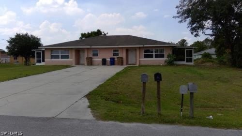 Ranch-style house with a front lawn