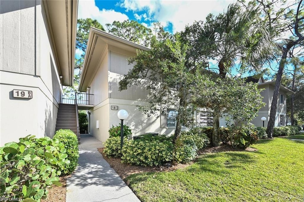 View of front of home featuring stairs and a front lawn