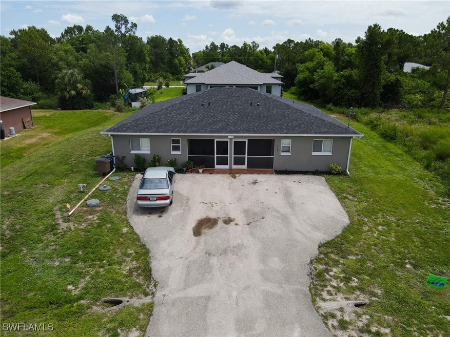 Ranch-style home featuring a front lawn, roof with