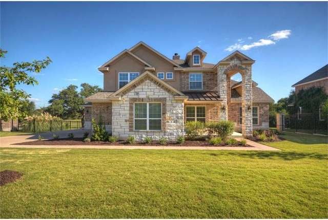 Attractive brick and stone home with side entry ga