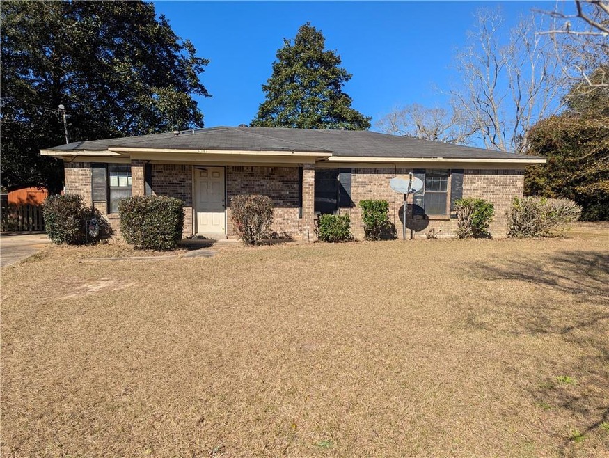 Single story home with a front lawn