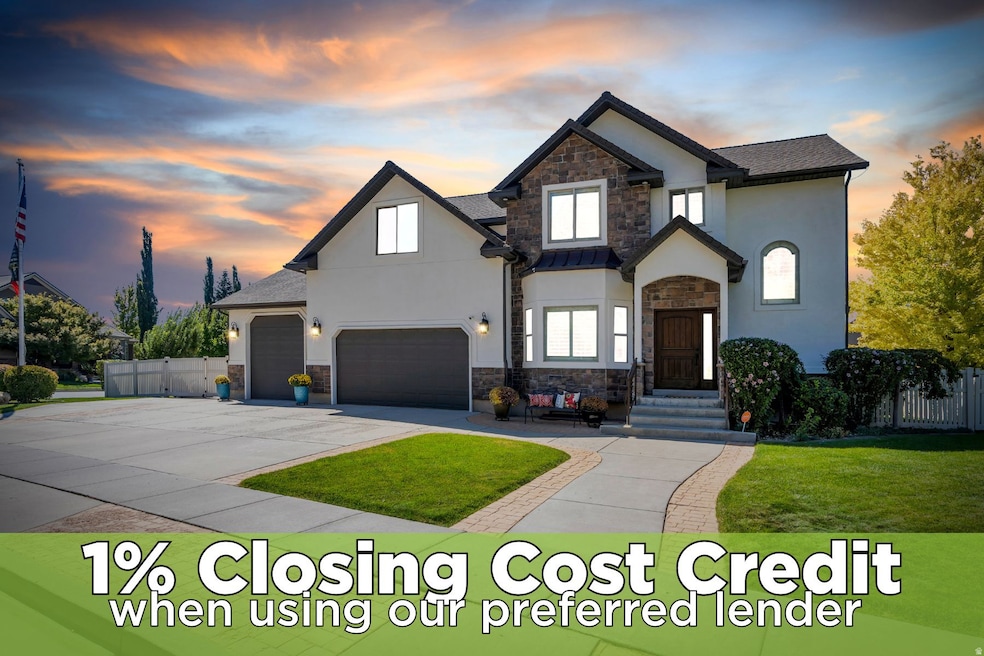 View of front of house featuring stone siding, stucco siding, and concrete driveway
