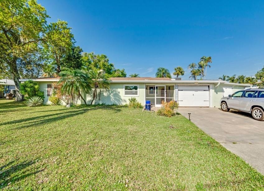 Single story home featuring a garage and a front l