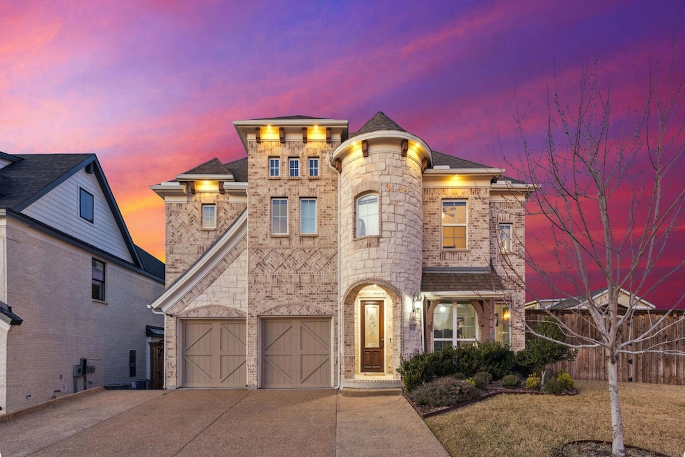View of front of house with a yard and a garage