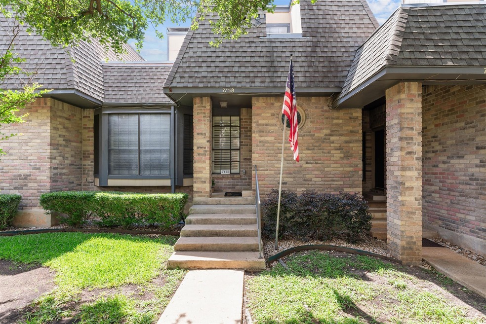 Doorway to property with brick siding, mansard ro