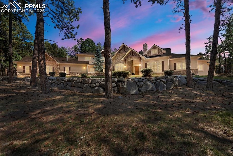 View of front facade with stone siding, a chimney, and stucco siding
