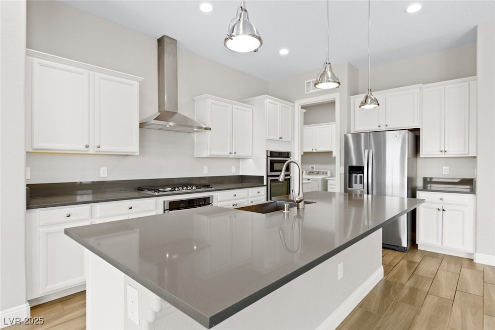 Kitchen with wall chimney exhaust hood, stainless
