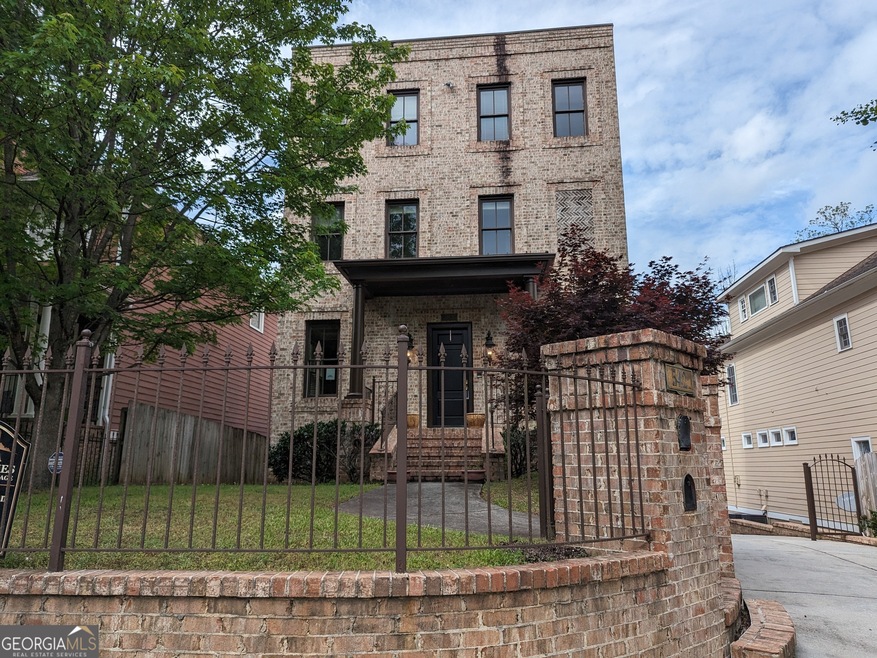 Beautiful brick house with a stately, fenced yard 