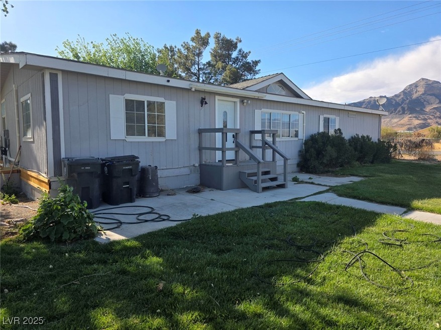 Rear view of house featuring a yard, a mountain vi
