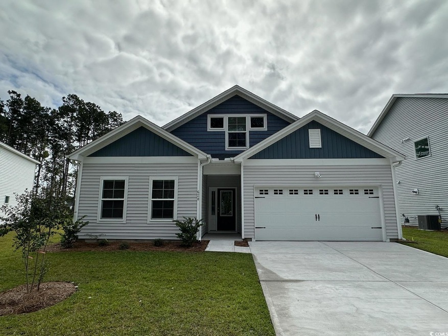 Craftsman-style home with a front yard, a garage, 
