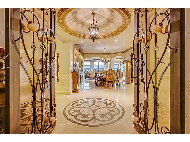 Entry Hall. Custom Iron Door Entry with Onyx Accen