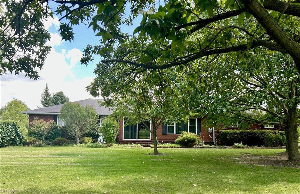 Front view of the home showing beautiful trees and