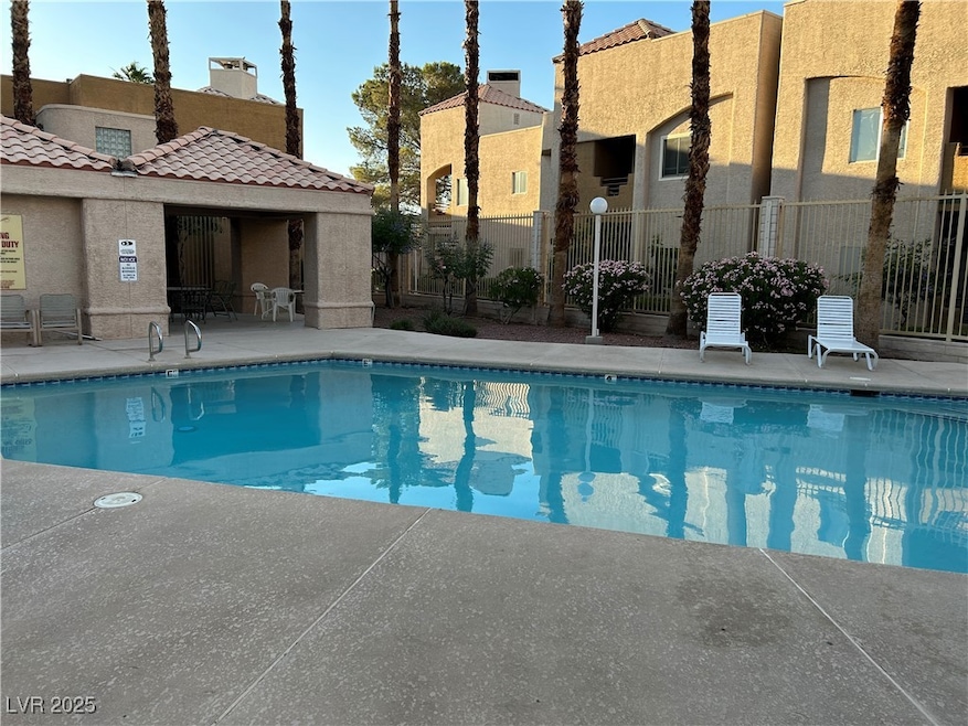 Community pool with a patio