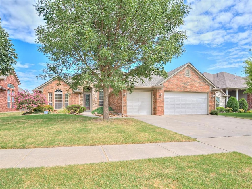 View of front of home with a garage and a front la