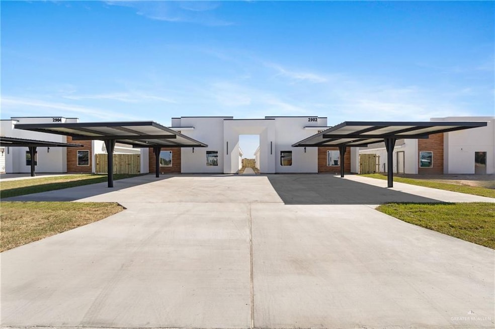 Modern home with a front yard and stucco siding
