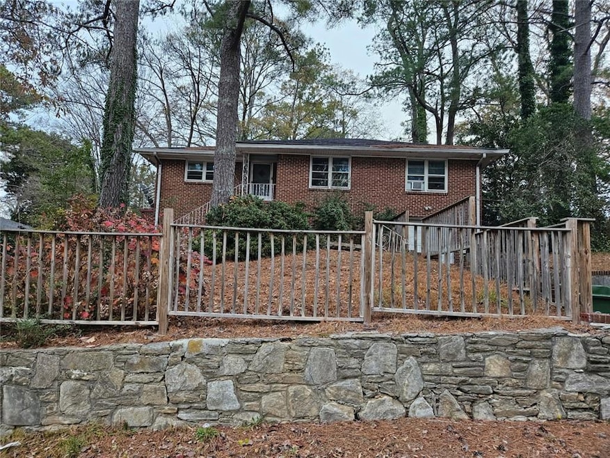 View of front of property with a garage, brick sid