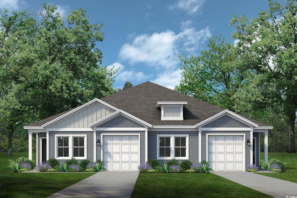 View of front of property with board and batten siding, a front lawn, and driveway