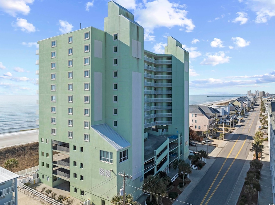 View of property with a beach view and a water vie