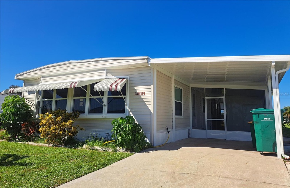 Front of house/New carport and gutters.