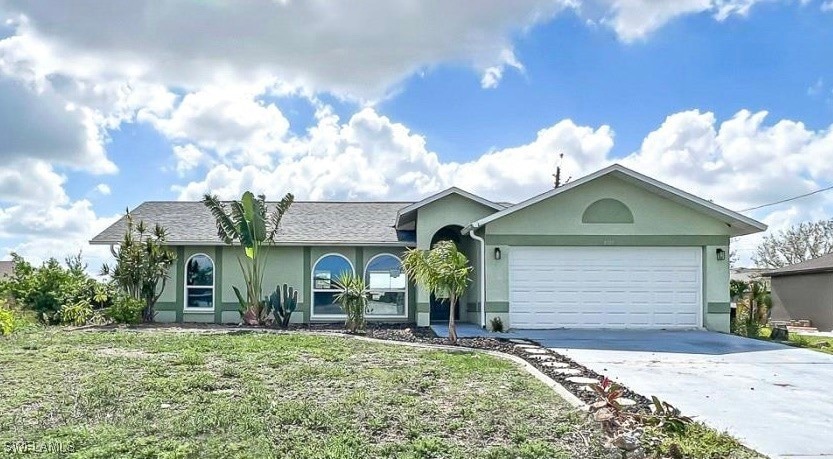 Ranch-style home with stucco siding, concrete driv