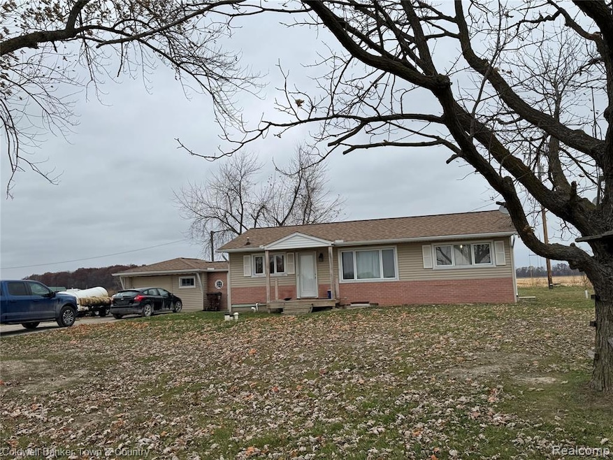 View of front of home featuring brick siding and a shingled roof