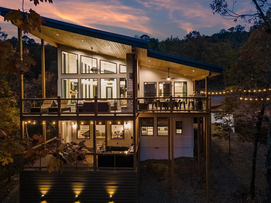 View of back of the home at dusk showing both of t