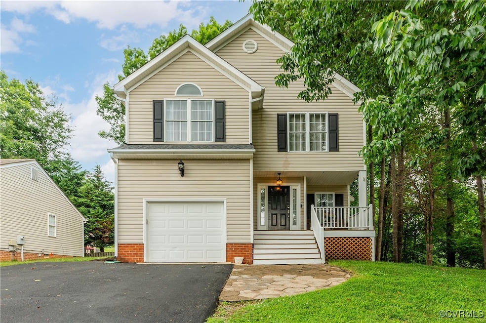View of front of home with an attached garage, a p