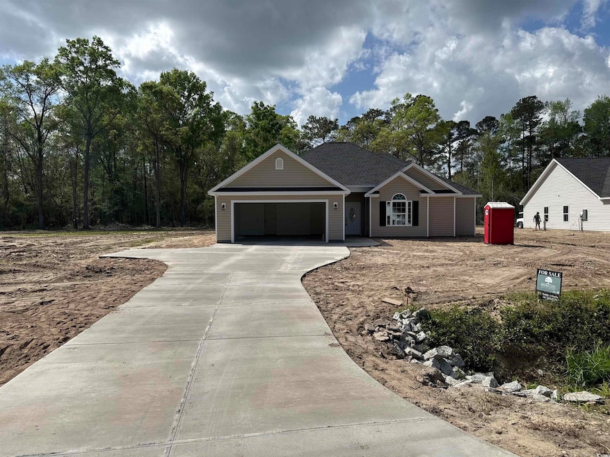 Single story home with concrete driveway and an at