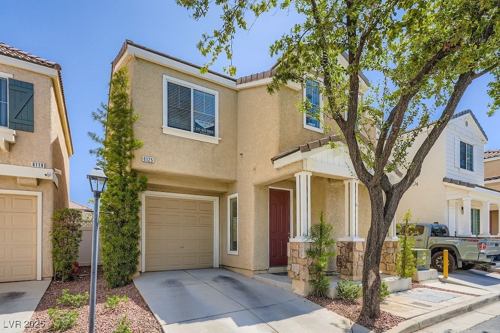View of front of house with stucco siding, an atta