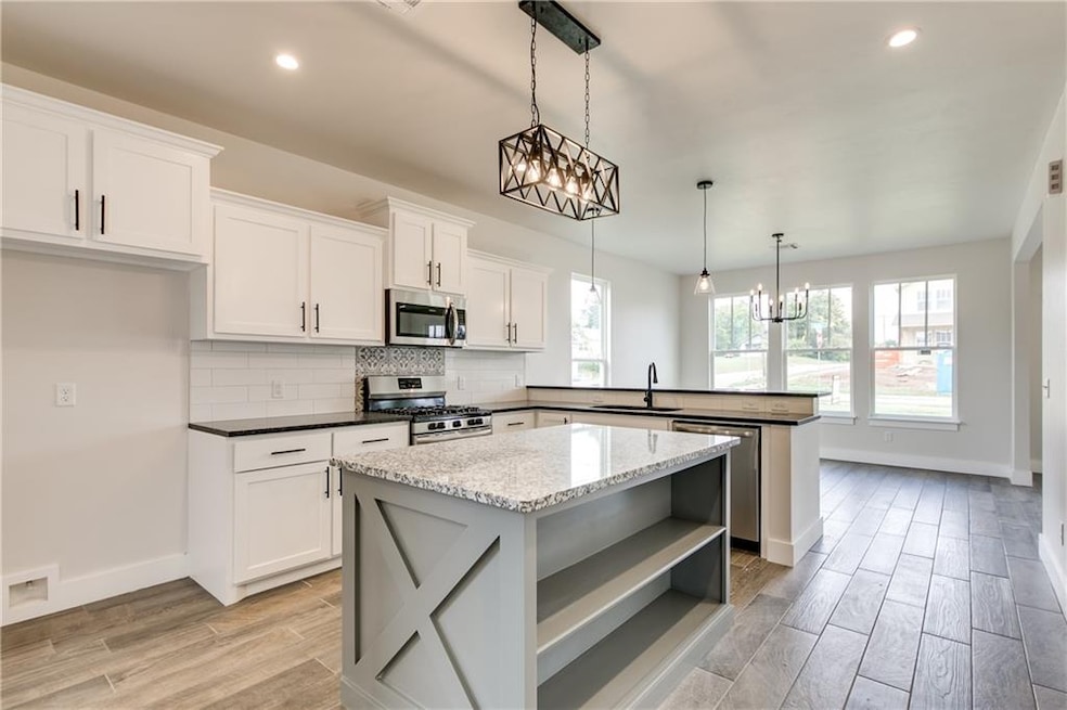 Open concept kitchen with center island, stainless