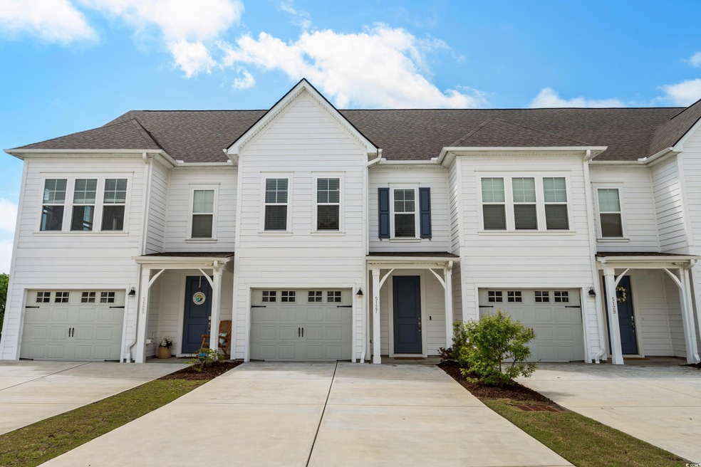Townhome / multi-family property with driveway, a 
