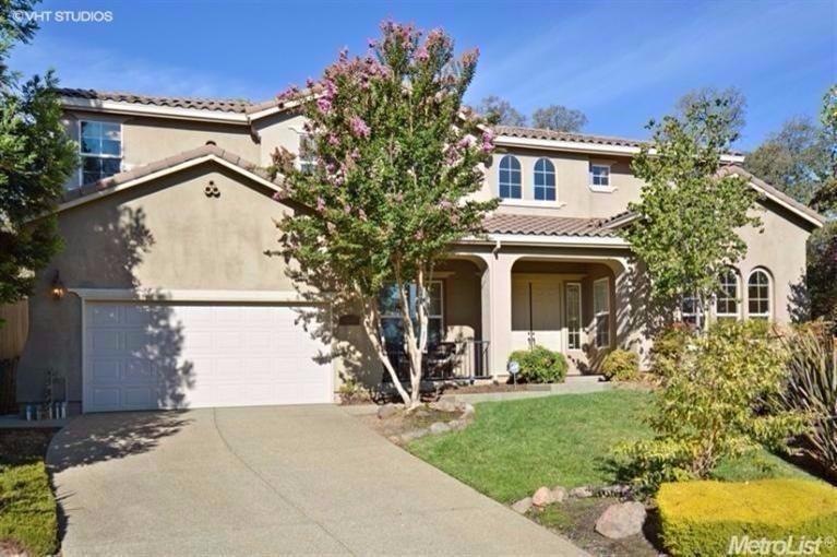 Front of home shows the tile roof, stucco siding, 