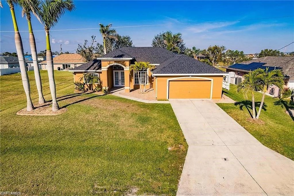 Ranch-style home with a garage and a front lawn