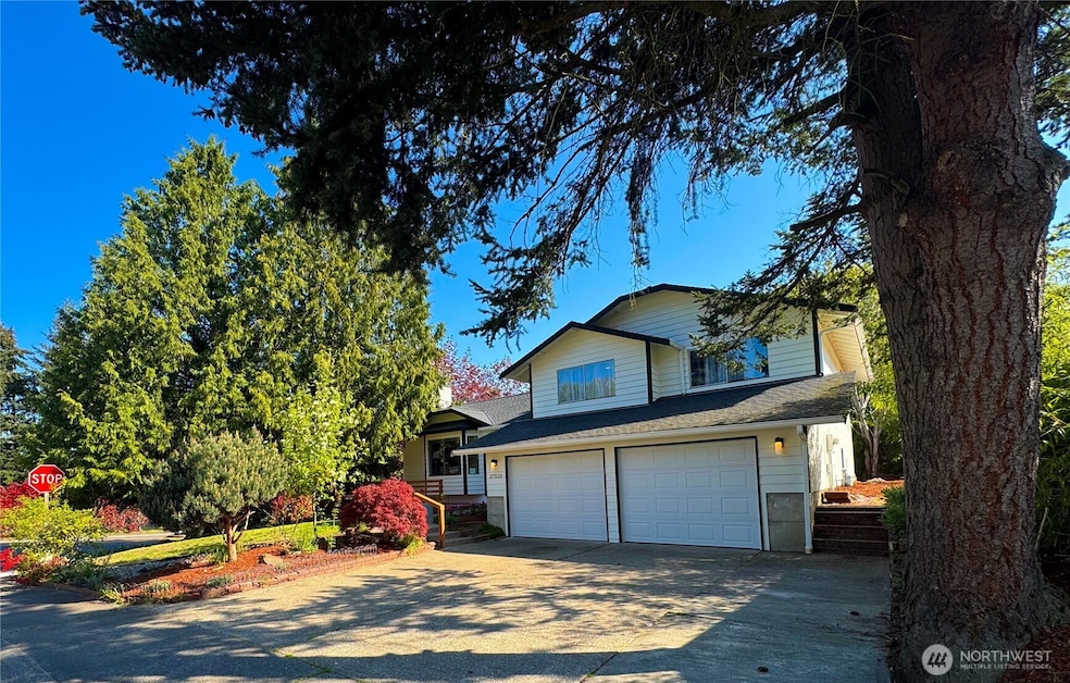 Mature trees and landscaping shade this house. It also offers two car-garage with driveway easily fitting an additional 3 cars