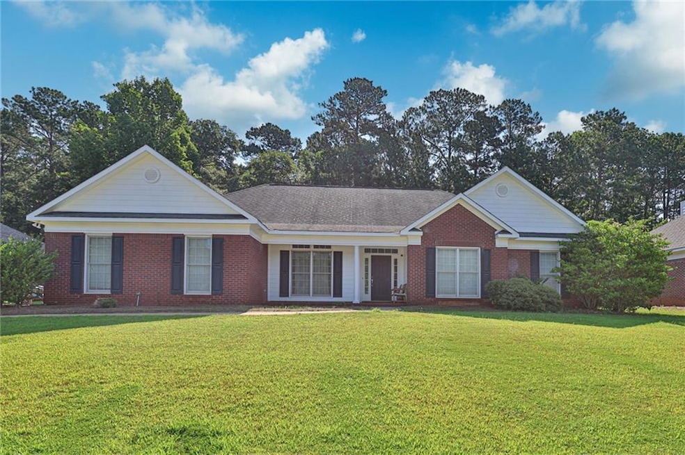 Ranch-style home featuring a front yard and brick siding