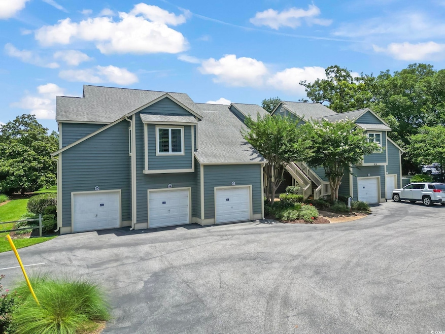 View of front of home featuring a garage, a shingled roof, and driveway