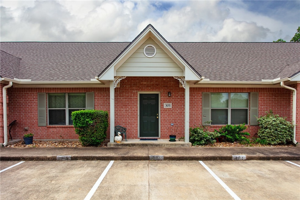 View of front of house with brick siding, a shingl