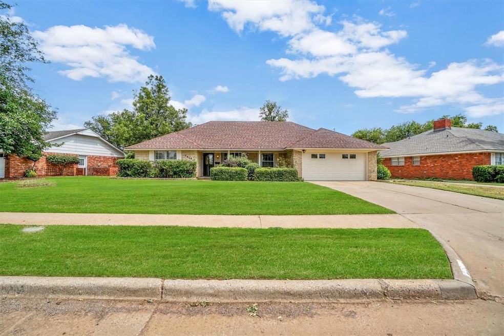 Ranch-style house with a front lawn and a garage
