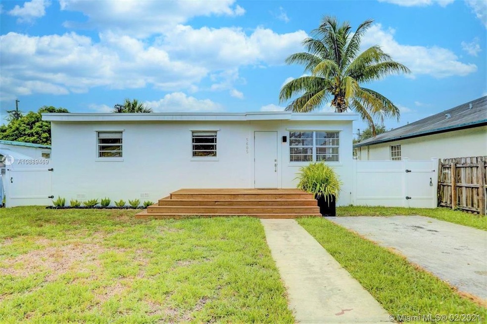 Home exterior front view. Brand new white fencing encloses the spacious backyard