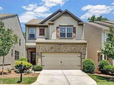 Craftsman house with concrete driveway, an attached garage, and brick siding