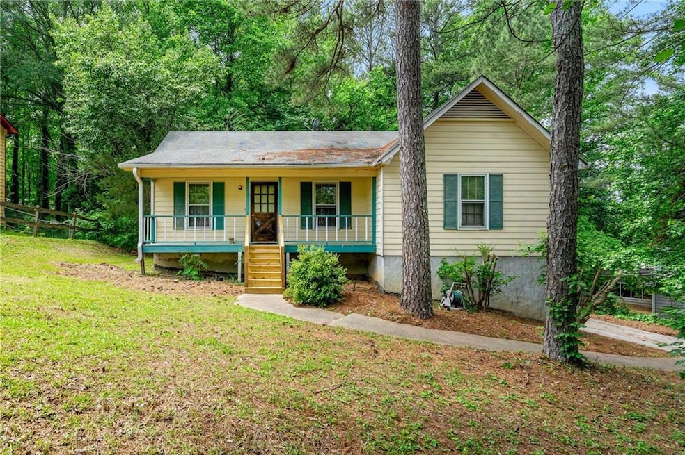 View of front of house featuring covered porch and a front lawn